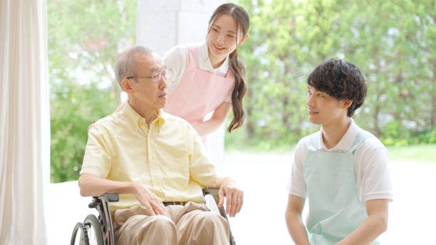 portrait of old man and young caregiver in the nusing home